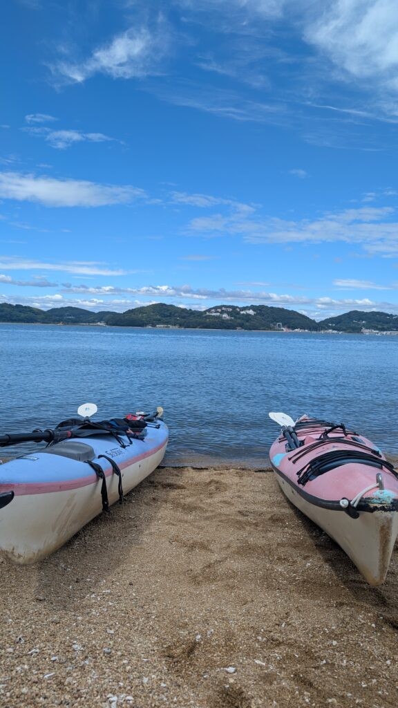 青空と瀬戸内海を背景に、浜辺に並ぶ2艇のシーカヤック